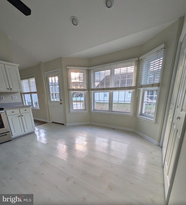 interior space featuring ceiling fan, light wood-type flooring, and a wealth of natural light