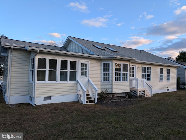 back house at dusk with a yard