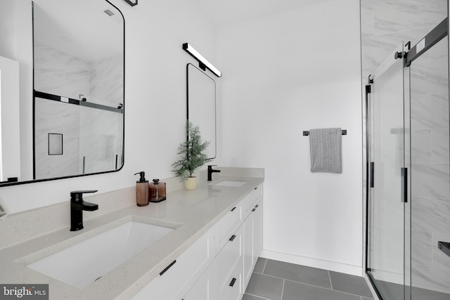 bathroom with tile patterned flooring, vanity, and a shower with door