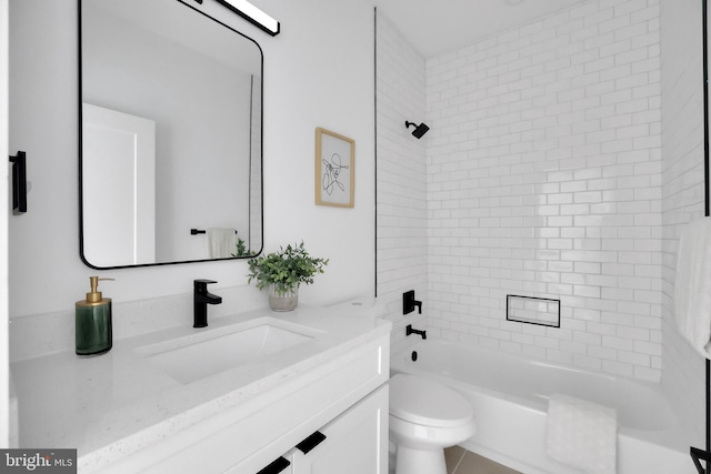 full bathroom with vanity, toilet, and tiled shower / bath