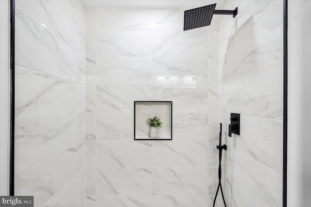 interior details with a tile shower