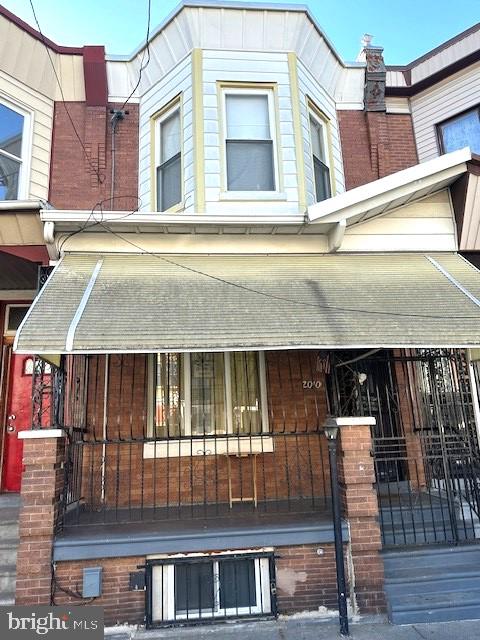 view of side of property with covered porch