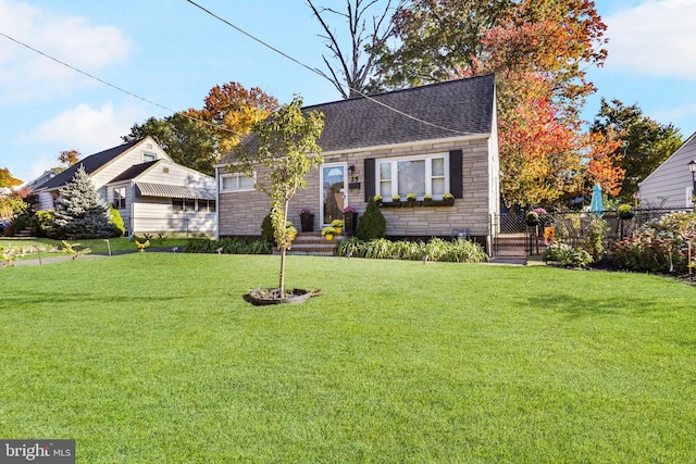 bungalow-style house featuring a front yard