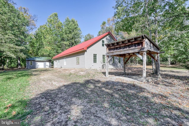 view of side of home featuring a storage shed and a wooden deck