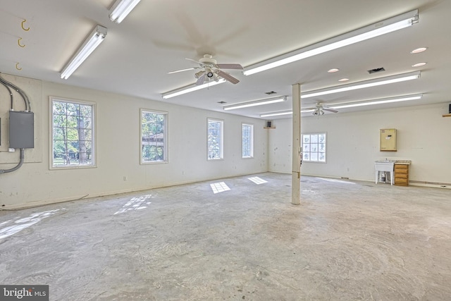 garage with electric panel and ceiling fan