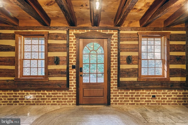 foyer entrance with beam ceiling and wood ceiling