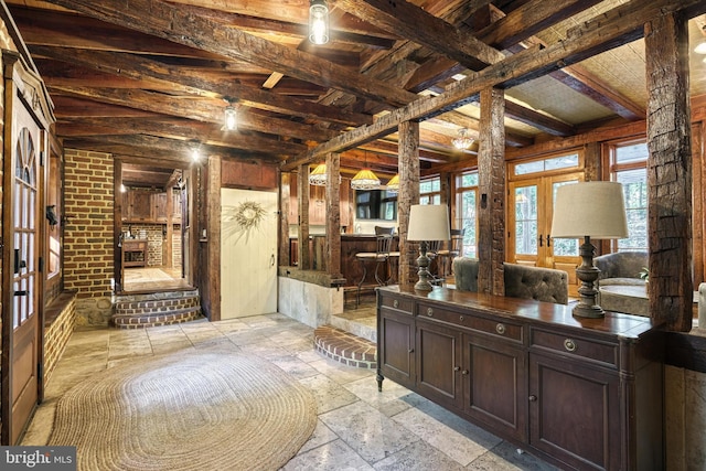 interior space featuring french doors, beam ceiling, and vanity