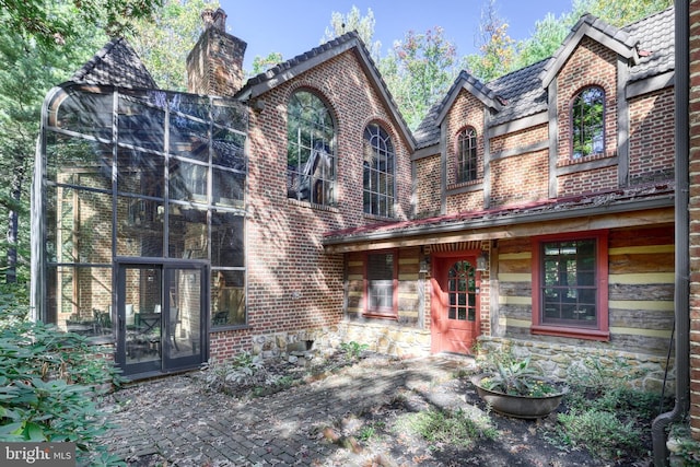 view of front of house with a sunroom