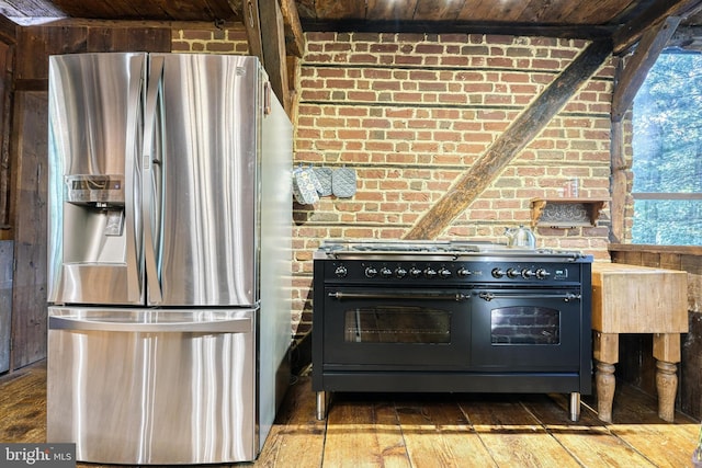 kitchen featuring hardwood / wood-style flooring, stainless steel refrigerator with ice dispenser, wooden ceiling, brick wall, and double oven range