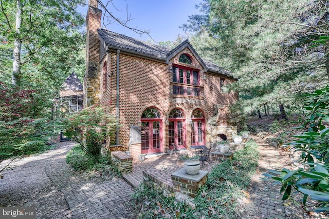 back of house featuring a patio and french doors