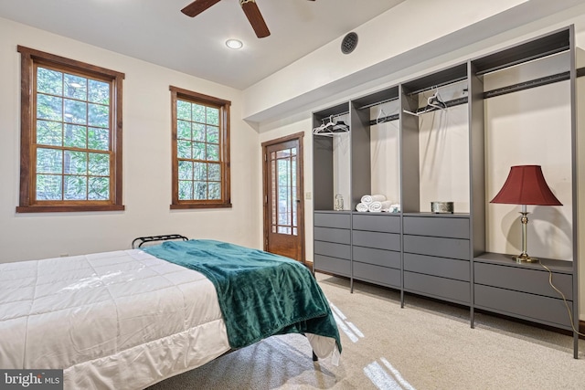 bedroom with a closet, ceiling fan, and carpet flooring