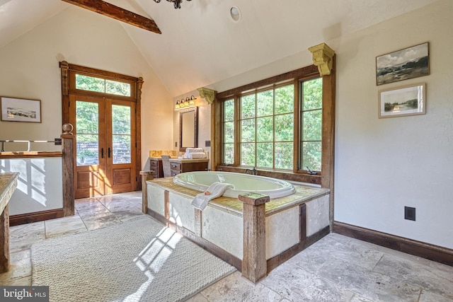 bathroom featuring vanity, french doors, vaulted ceiling with beams, and a relaxing tiled tub