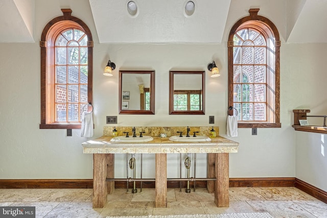 bathroom featuring vanity and vaulted ceiling