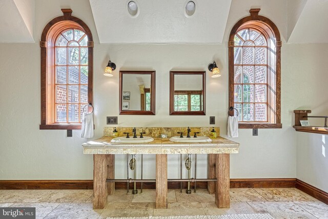 995 Black Gap Rd, Fayetteville, PA 17222 - bathroom featuring baseboards, stone tile floors, plenty of natural light, and a sink