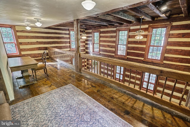 hallway with a wealth of natural light and hardwood / wood-style flooring