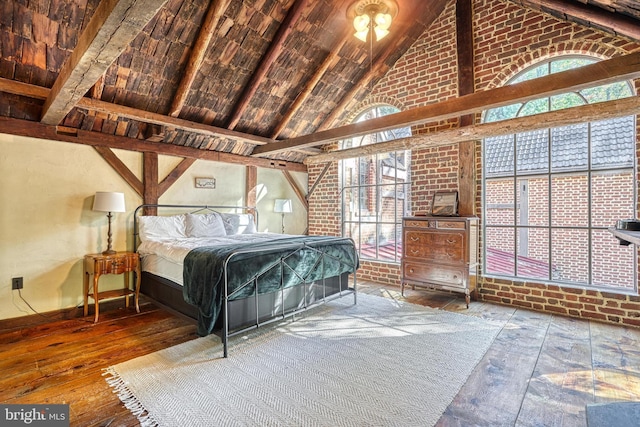 bedroom featuring beam ceiling, high vaulted ceiling, and wood-type flooring