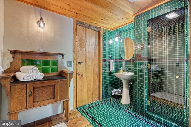 bathroom featuring tile patterned flooring, wooden ceiling, sink, and tiled shower