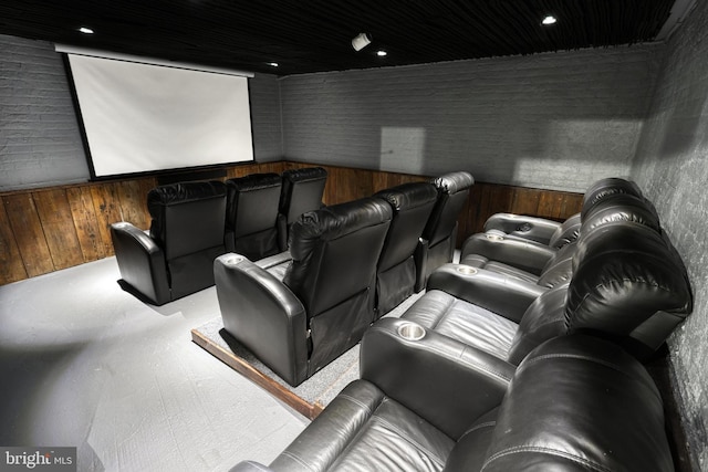 home theater with wooden walls