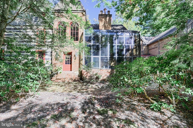 995 Black Gap Rd, Fayetteville, PA 17222 - back of property with a chimney, brick siding, and a sunroom