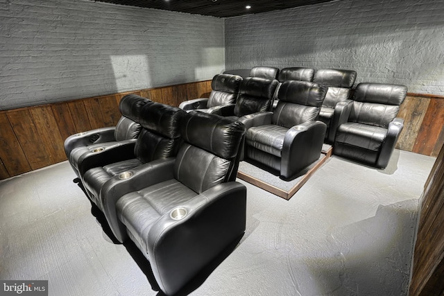 home theater room featuring wood walls