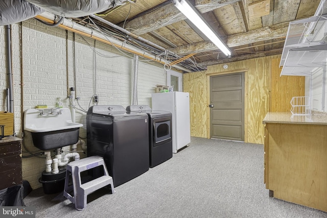 laundry area with washer and dryer, sink, and carpet