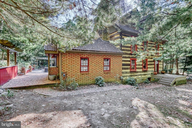 995 Black Gap Rd, Fayetteville, PA 17222 - back of property featuring a tile roof, a deck, and brick siding