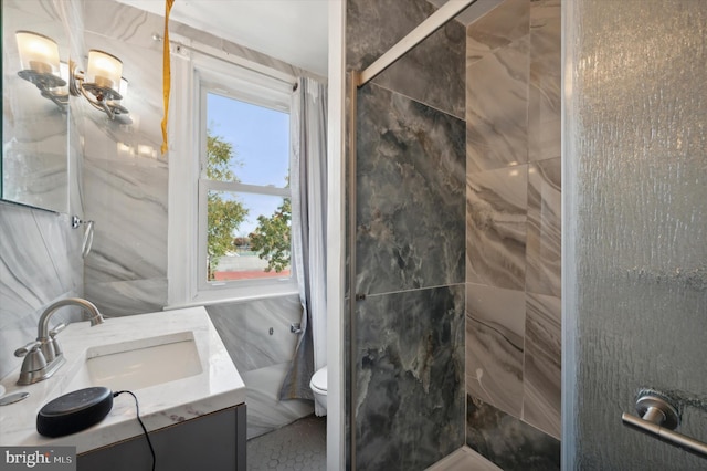 bathroom with toilet, vanity, a shower with door, and tile walls