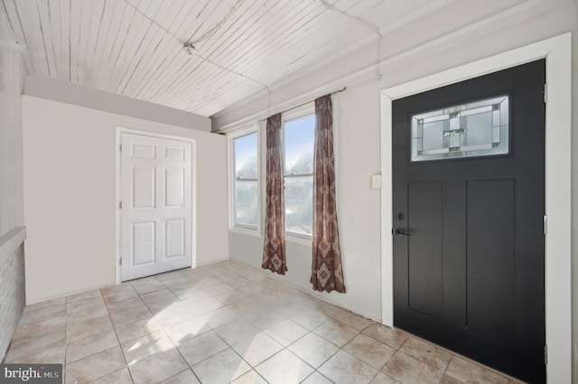 entrance foyer featuring wood ceiling and light tile patterned floors