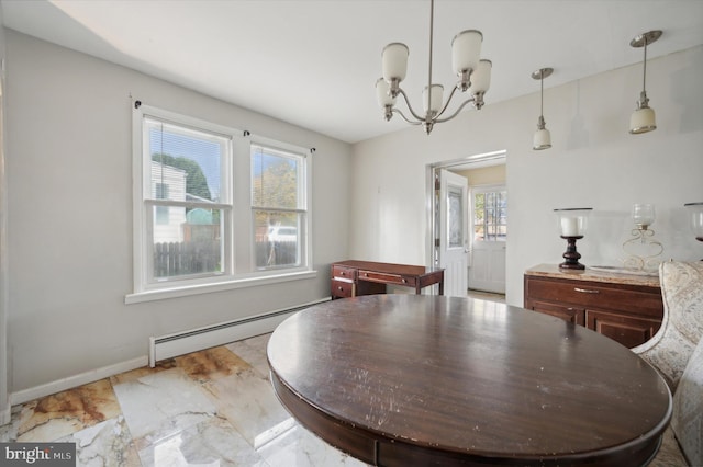 dining room featuring a chandelier and a baseboard heating unit