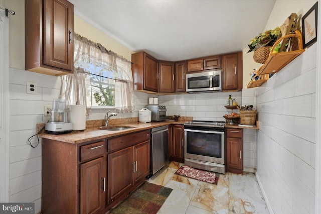 kitchen with decorative backsplash, sink, and stainless steel appliances