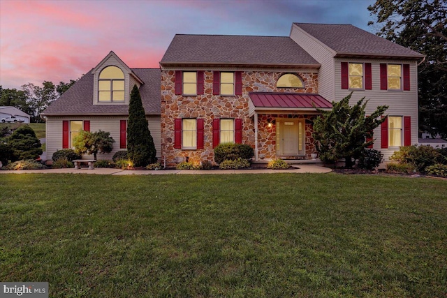 colonial-style house with a lawn