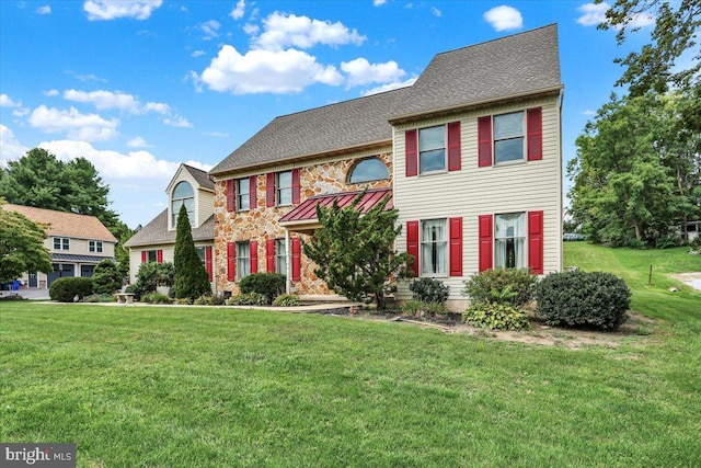 colonial-style house with a front yard