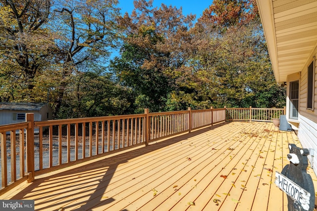 wooden terrace with a storage shed