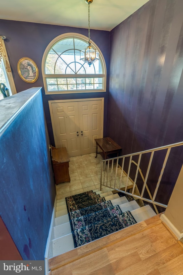 foyer featuring an inviting chandelier and tile patterned flooring