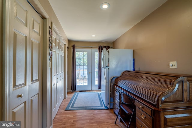 doorway with french doors and light wood-type flooring