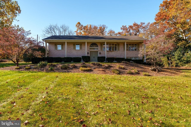 raised ranch featuring a front lawn