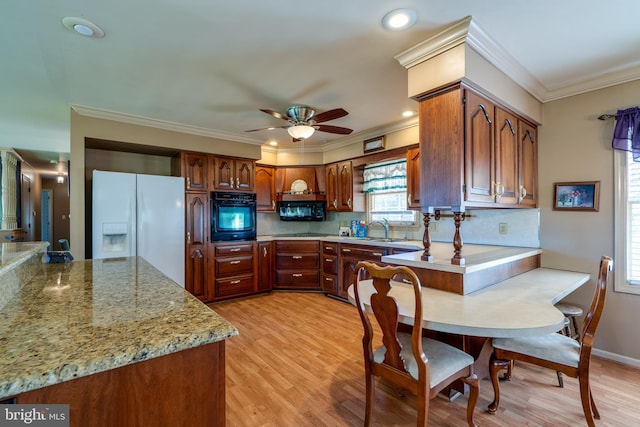 kitchen with decorative backsplash, black appliances, light hardwood / wood-style floors, crown molding, and sink