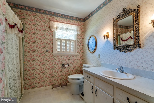 bathroom featuring vanity and toilet