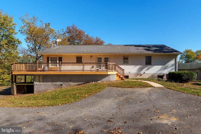 back of property with a wooden deck