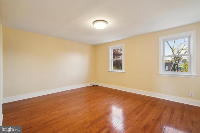 empty room with hardwood / wood-style flooring