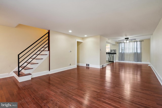 unfurnished living room with ceiling fan and dark hardwood / wood-style flooring