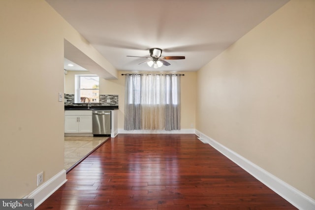 interior space with sink, wood-type flooring, and ceiling fan