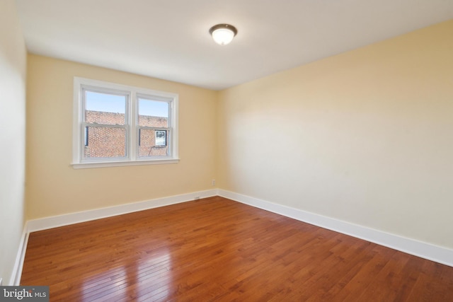 unfurnished room with hardwood / wood-style flooring