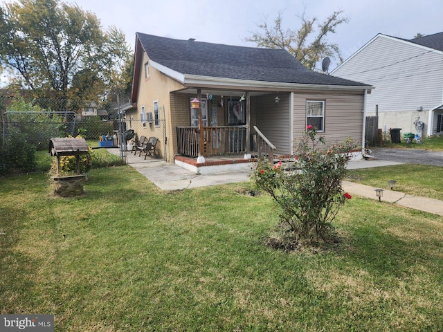 rear view of house featuring a yard