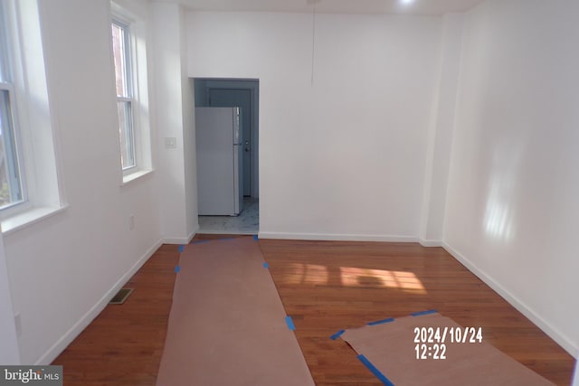 spare room featuring hardwood / wood-style floors and a healthy amount of sunlight