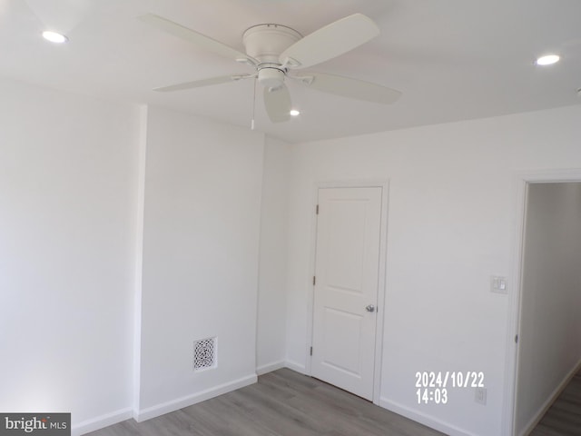 spare room with hardwood / wood-style flooring and ceiling fan