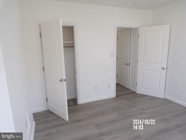 unfurnished bedroom featuring a closet and light hardwood / wood-style floors