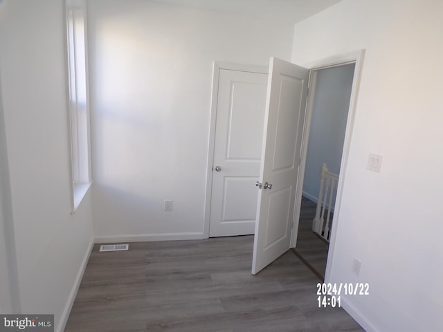 hallway with dark hardwood / wood-style flooring