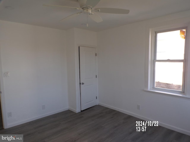 spare room featuring dark hardwood / wood-style flooring and ceiling fan