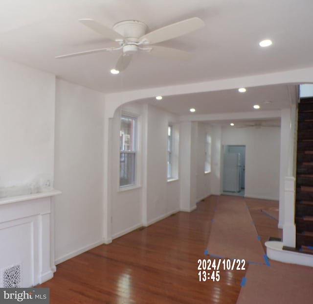 interior space featuring wood-type flooring and ceiling fan